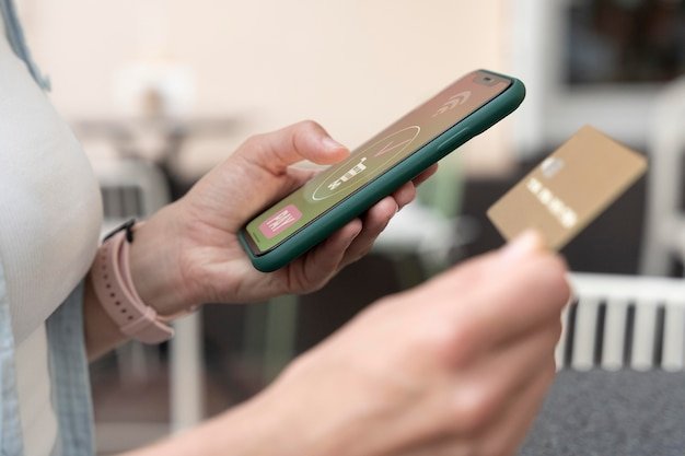 A close-up shot of a smartphone screen displaying a mobile payment interface. The interface shows options for Apple Pay, Google Pay, and a credit card, with security icons indicating a safe transaction. The background is blurred to focus on the payment options.