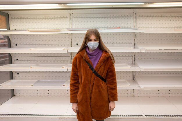 A photograph showing empty shelves in a retail store in the USA, symbolizing the impact of supply chain disruptions on product availability and consumer frustration.