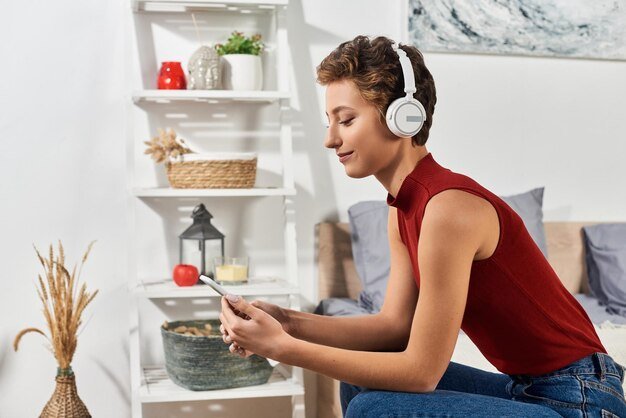 A person using a smartphone with a music streaming app open, showing a variety of equalizer presets and customization options, highlighting the user-friendly interface and personalized audio settings available.