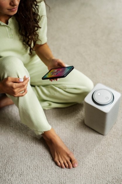 A lifestyle image showing a person using a smart home device in their living room, emphasizing convenience and modern living.
