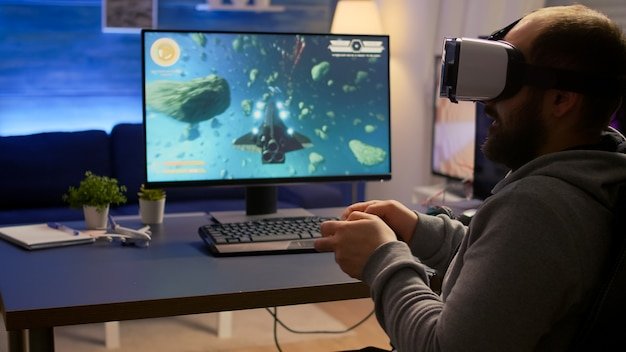 A gamer wearing a VR headset and holding motion controllers, fully immersed in a virtual reality action game on their PC. The PC setup is visible in the background, showcasing the powerful hardware required for VR gaming.